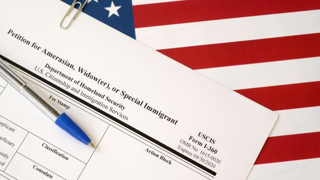 USCIS Form I-360 Petition on American flag background for immigration legal filing