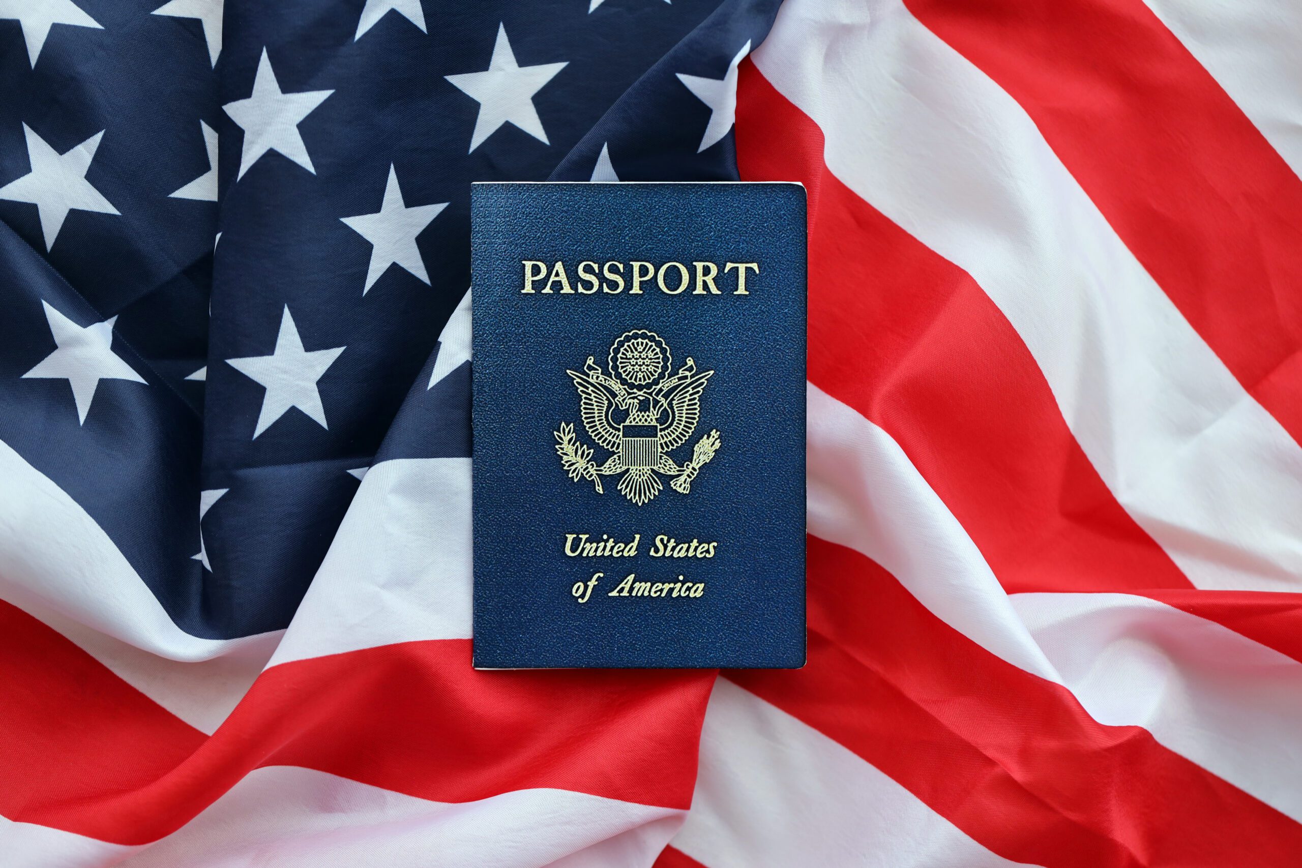 U.S. passport on the American flag background.