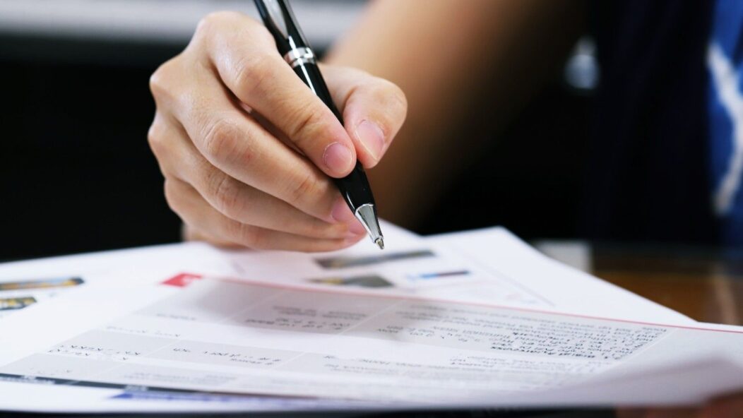 Close-up of U.S. immigration forms with pens on top, showing details of the application process.