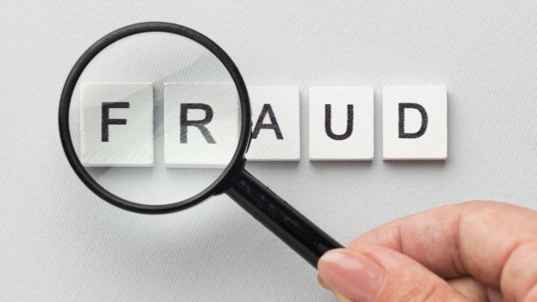 Magnifying glass over the word FRAUD highlighting OPT visa misrepresentation concerns