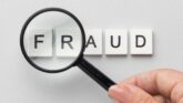 Magnifying glass over the word FRAUD highlighting OPT visa misrepresentation concerns