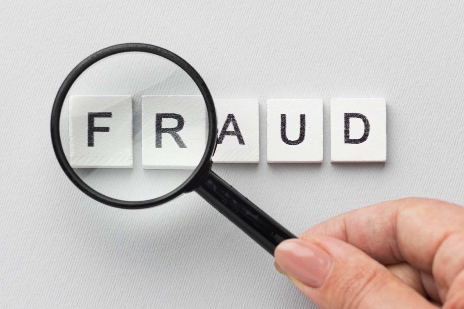 Magnifying glass over the word FRAUD highlighting OPT visa misrepresentation concerns